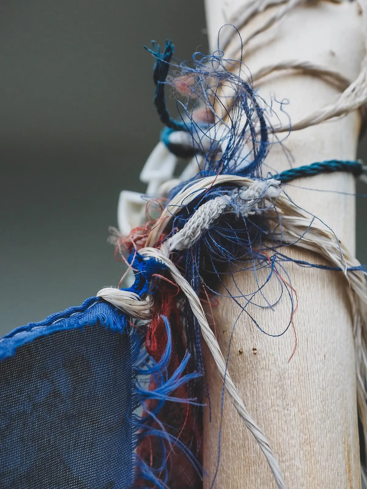 Frayed blue and white rope ends tied around a post, 2020