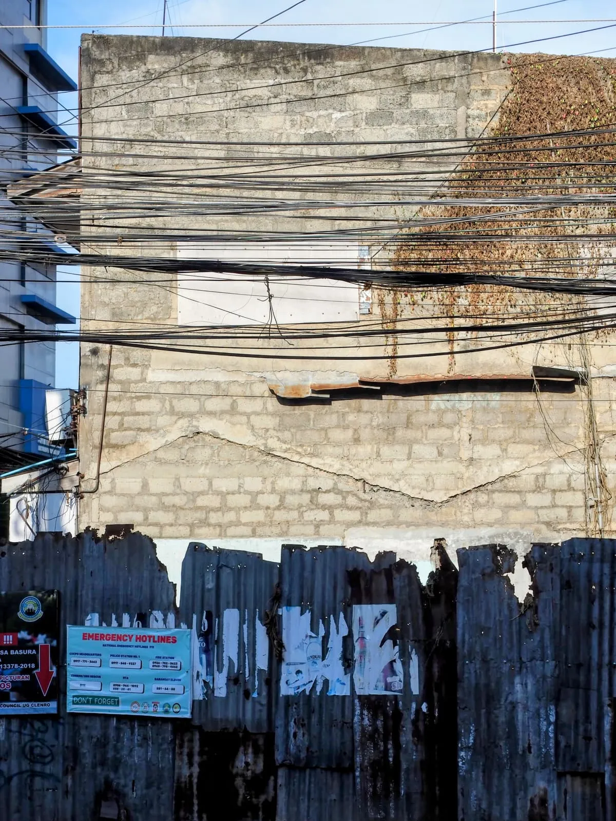 Dozens of cables strung in front of a block wall, 2025