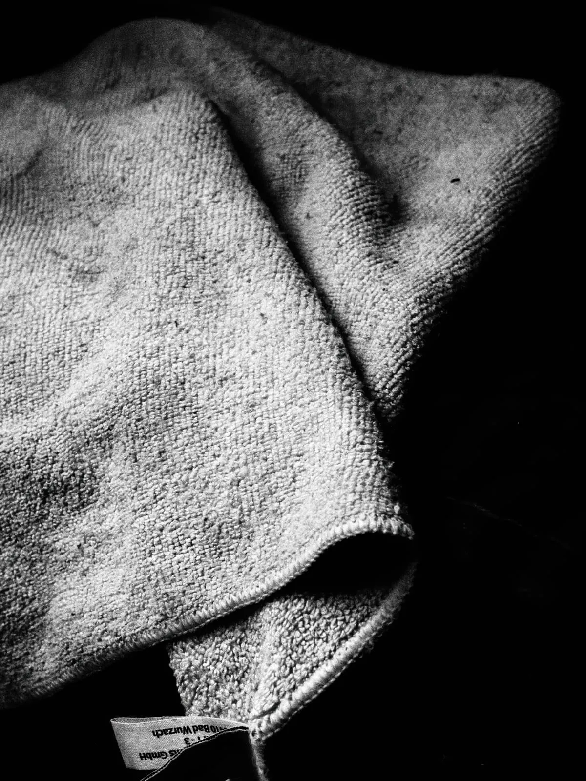 Black and white folded towel on black, 2020
