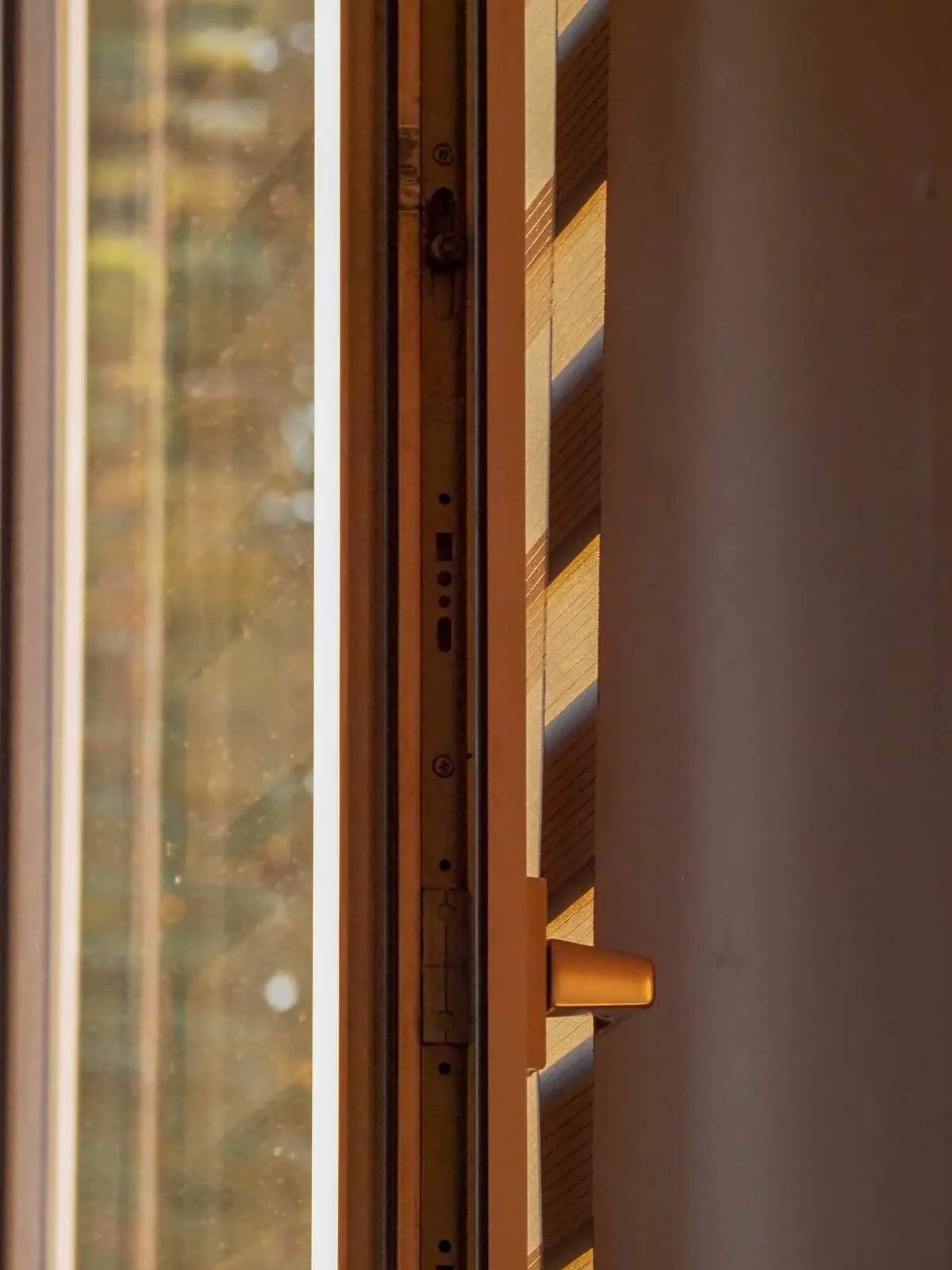 Edge of a wooden door and frame in warm light, 2020