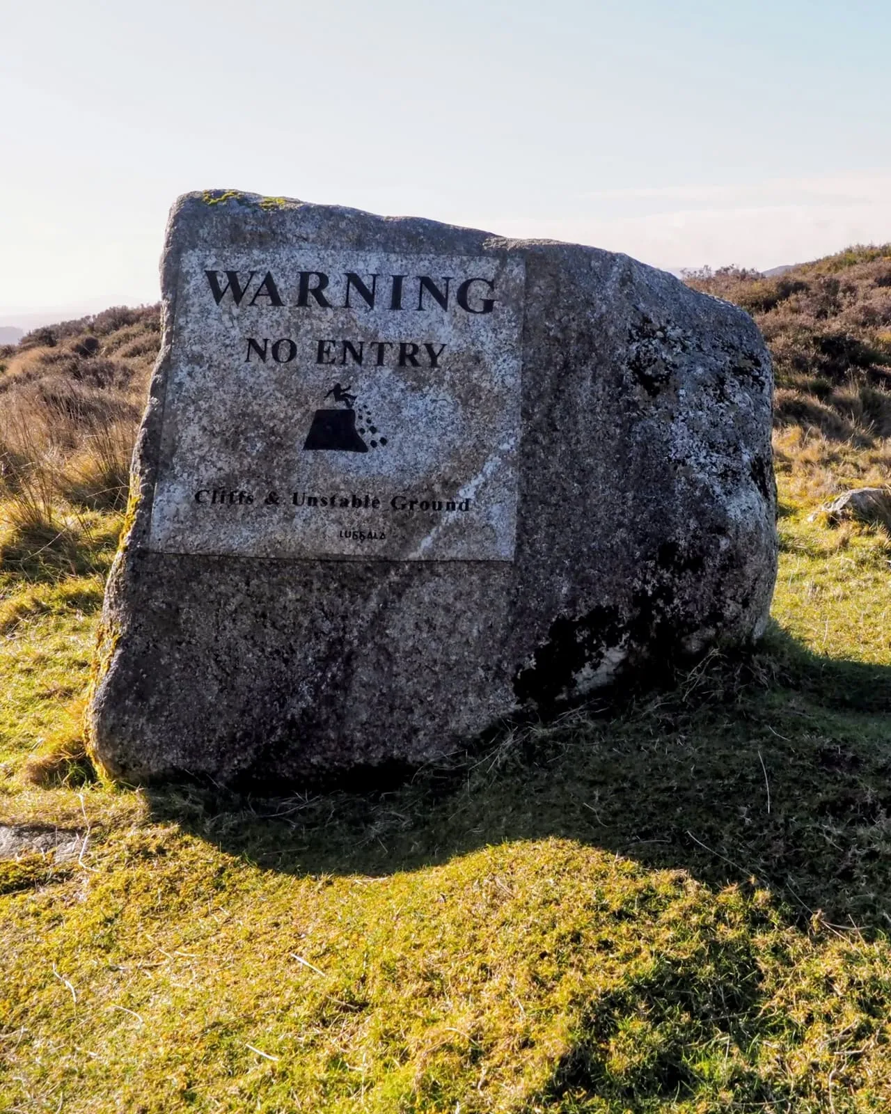 Boulder in a field engraved Warning No Entry, 2026