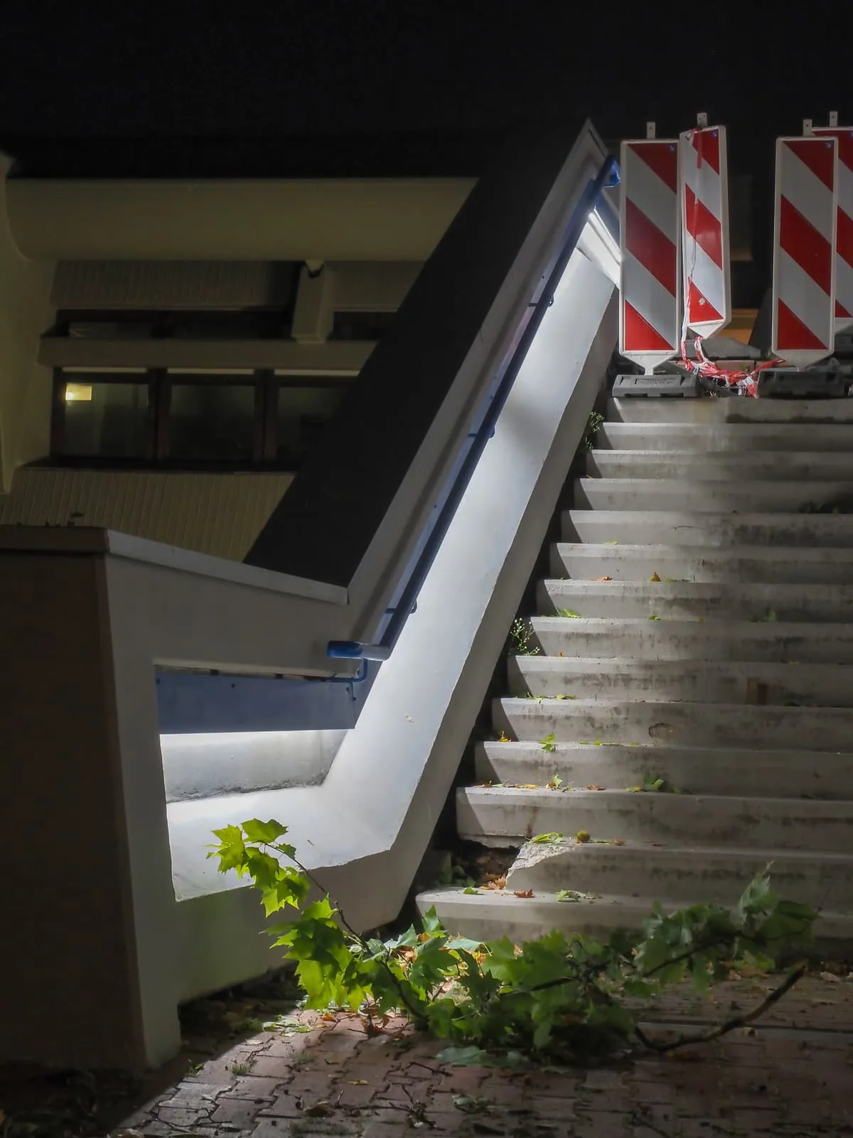 Concrete steps at night closed off with striped barriers, 2020