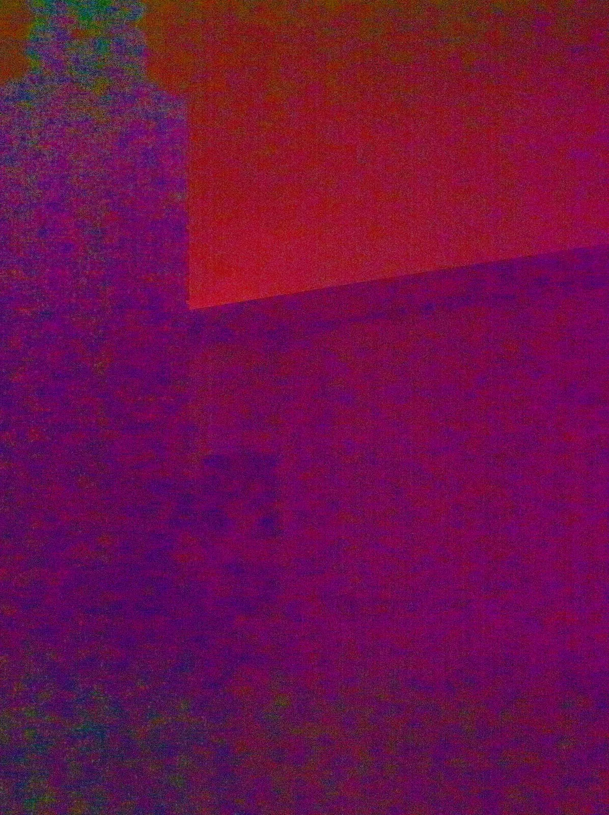 Heavy colour noise, a red sky above a dark violet wall, 2025