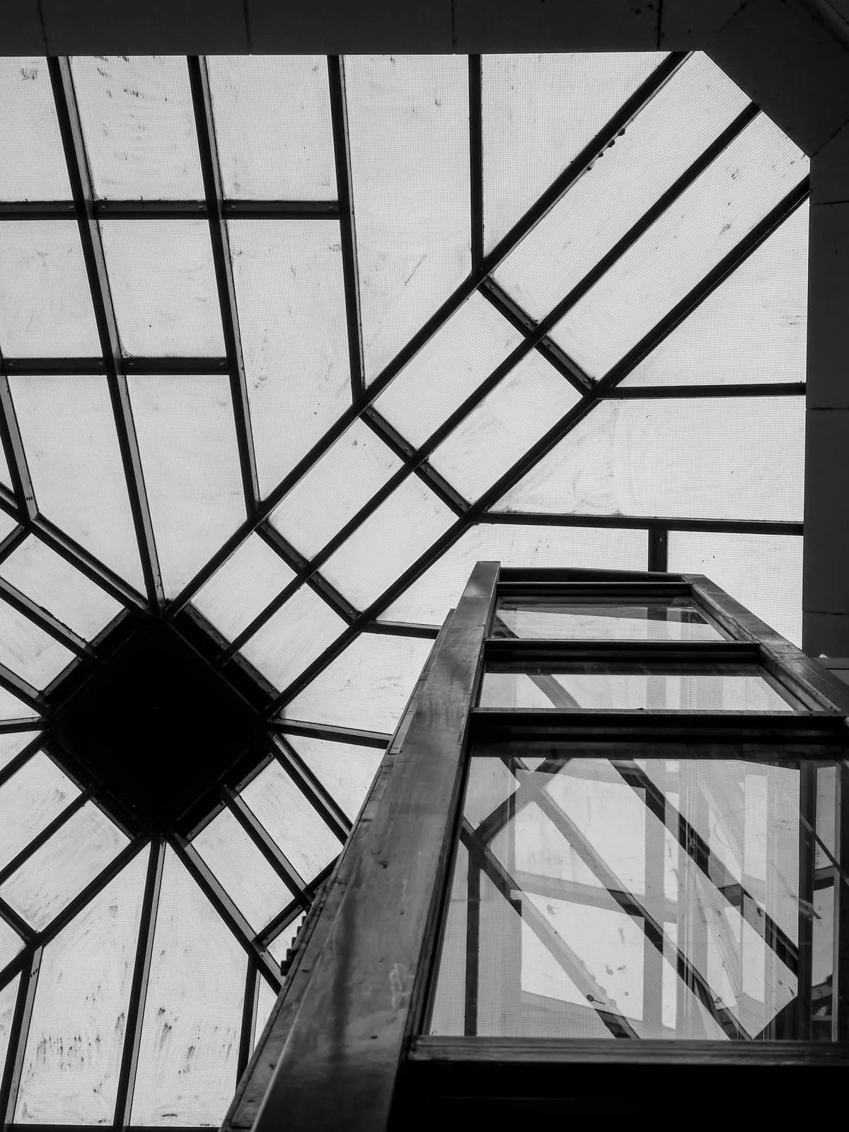 Black and white glass roof and lift shaft from below, 2020