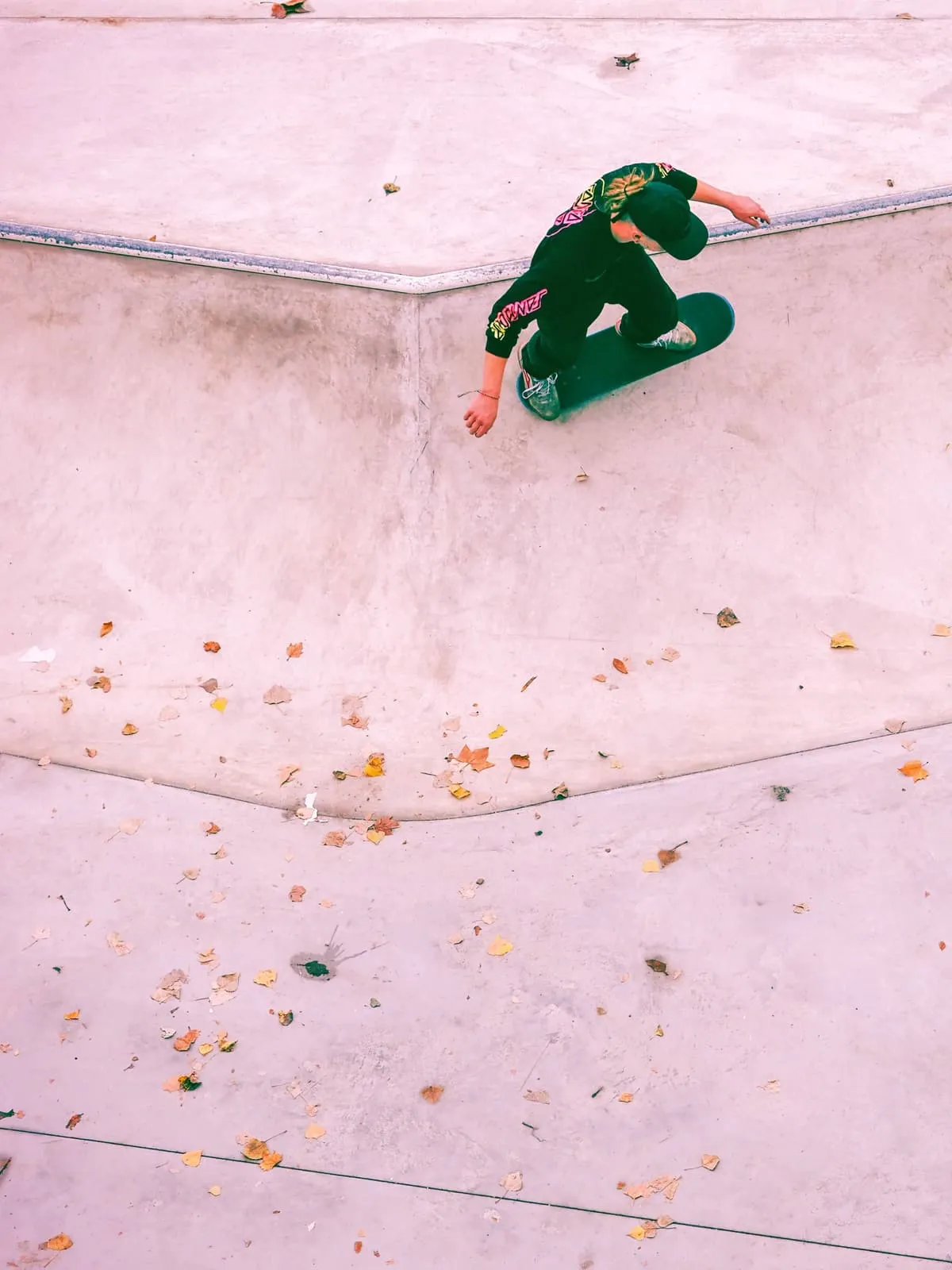 Skater from above on the pink edge of a concrete bowl, 2021