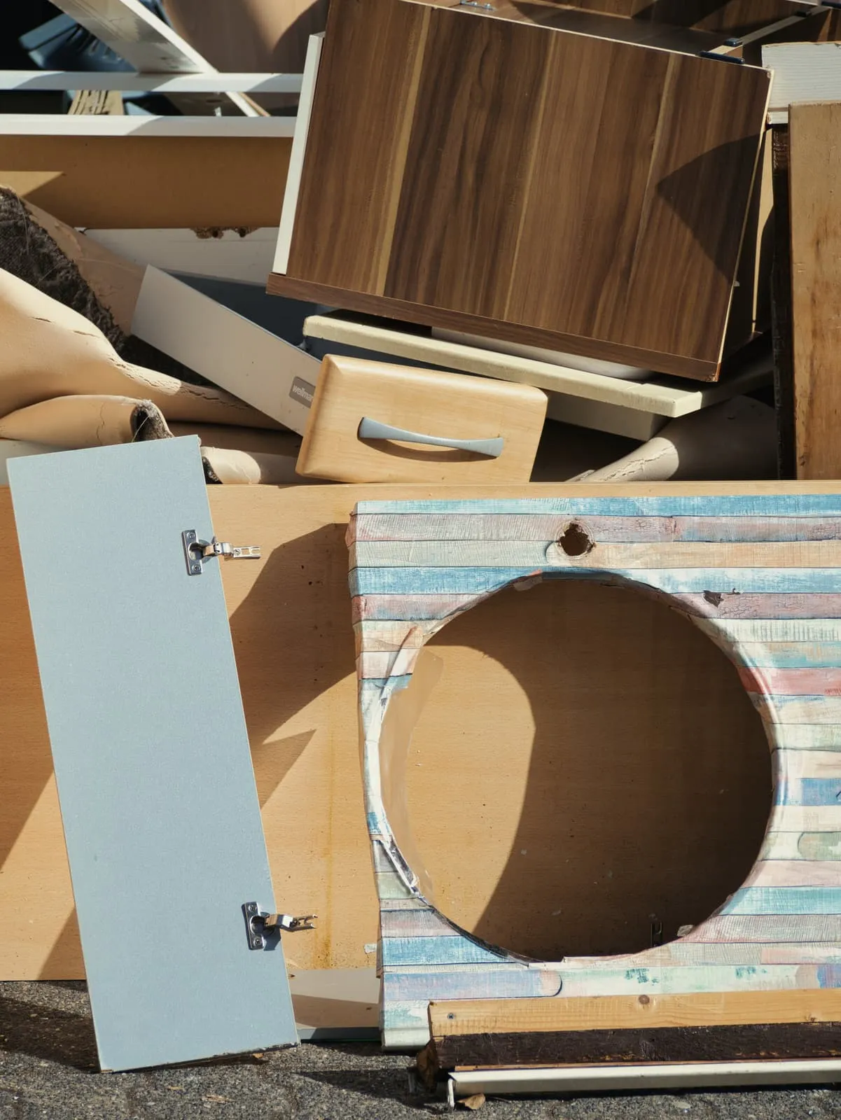 Discarded furniture boards and a speaker cabinet with a round hole, 2021